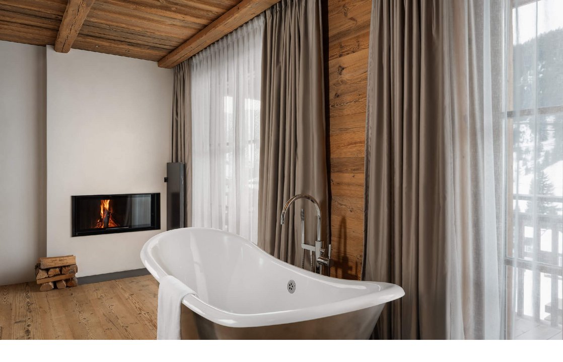 Freistehende Badewanne und Kamin.